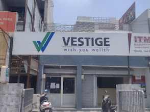 VESTIGE Vadodara Karelibagh Maxx DLCP logo